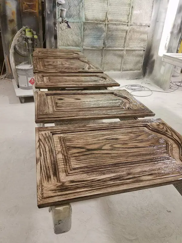 Cabinet doors laid out in a spray booth during refinishing